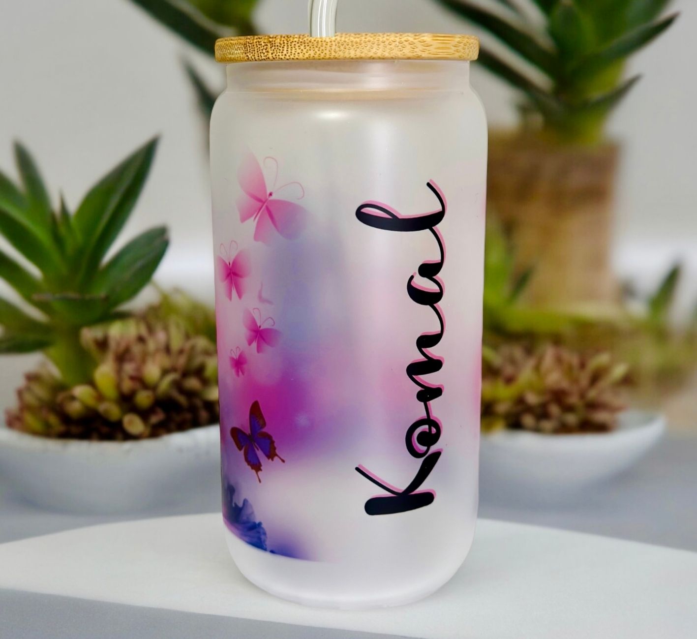 Transparent tumbler with butterfly designs and customisable name design.