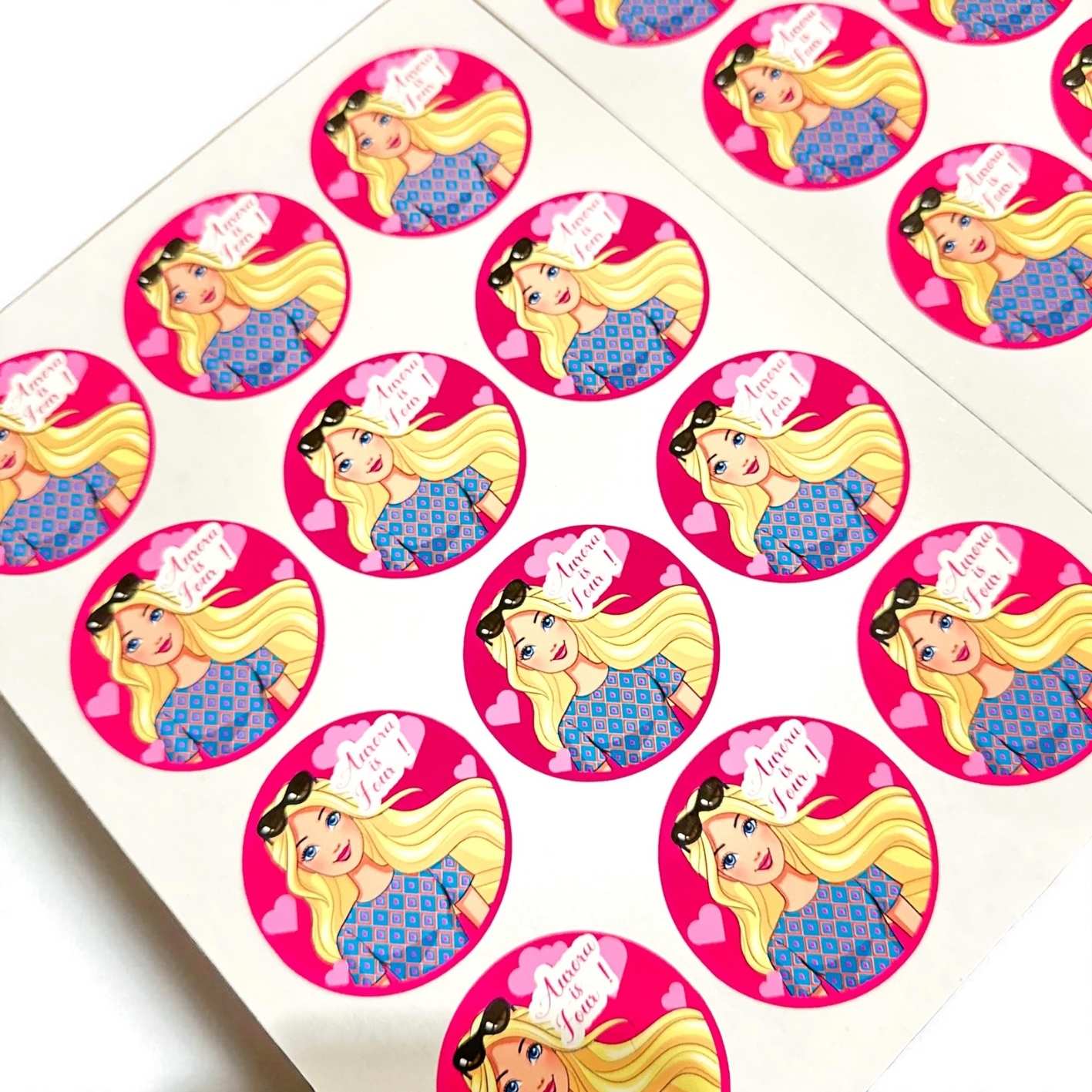 Stickers with a cartoon doll character on a pink background and Birthday celebrant's name