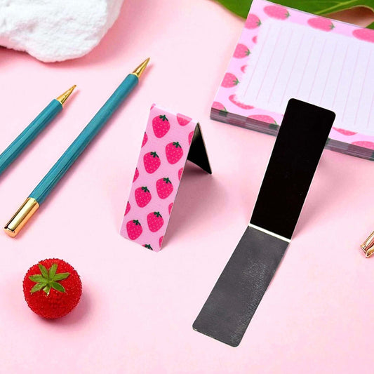 Custom strawberry-themed magnetic bookmark with black magnetic backing surrounded by elegant stationery - book accessories