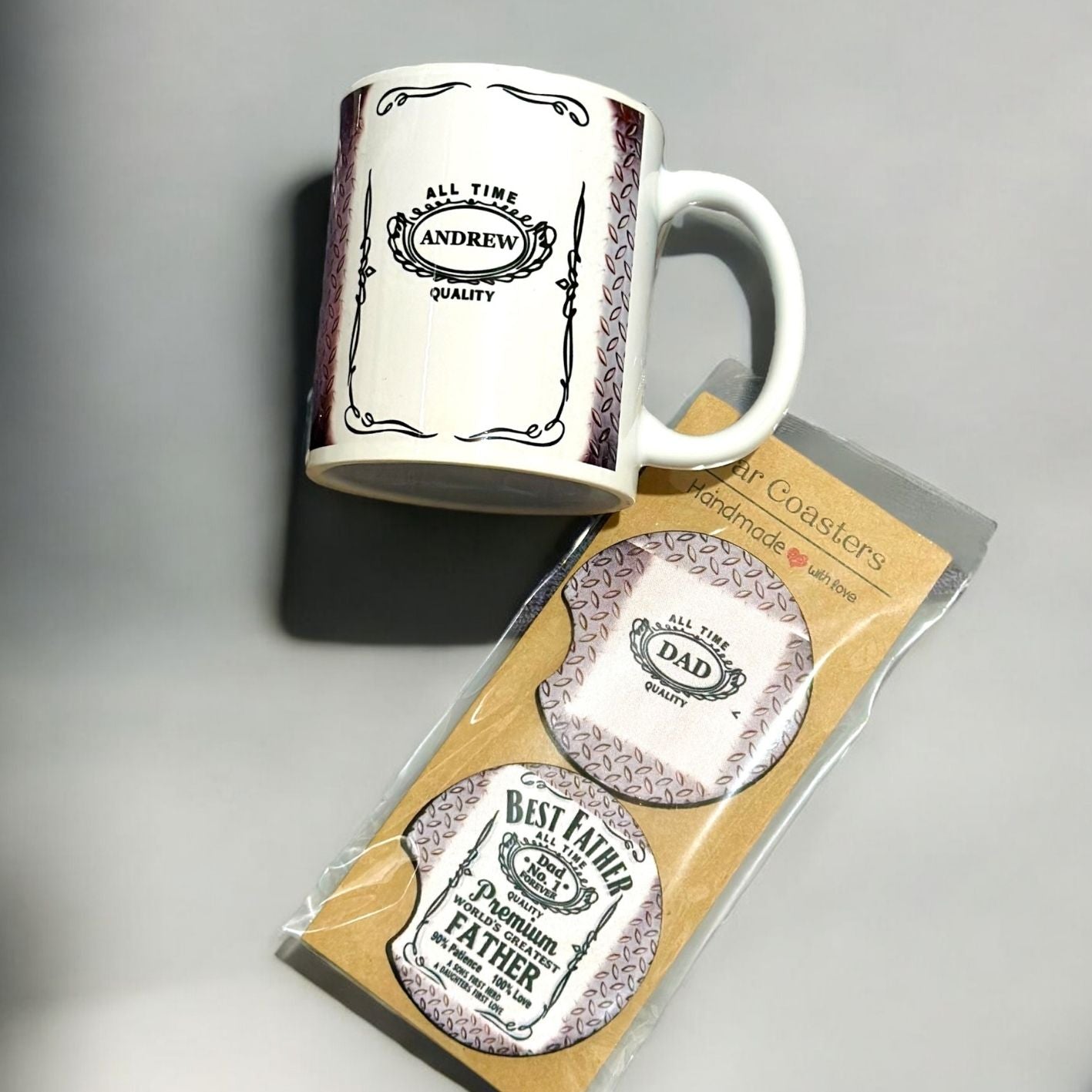 Mug and coasters with 'Dad' and 'Best Dad' text on a gray background