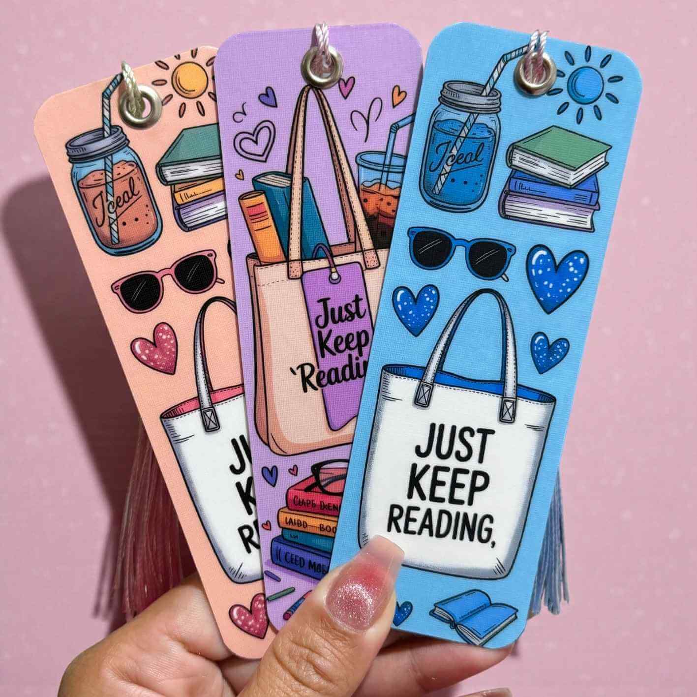 Colorful bookmarks with illustrations and 'Just Keep Reading' text on a pink background