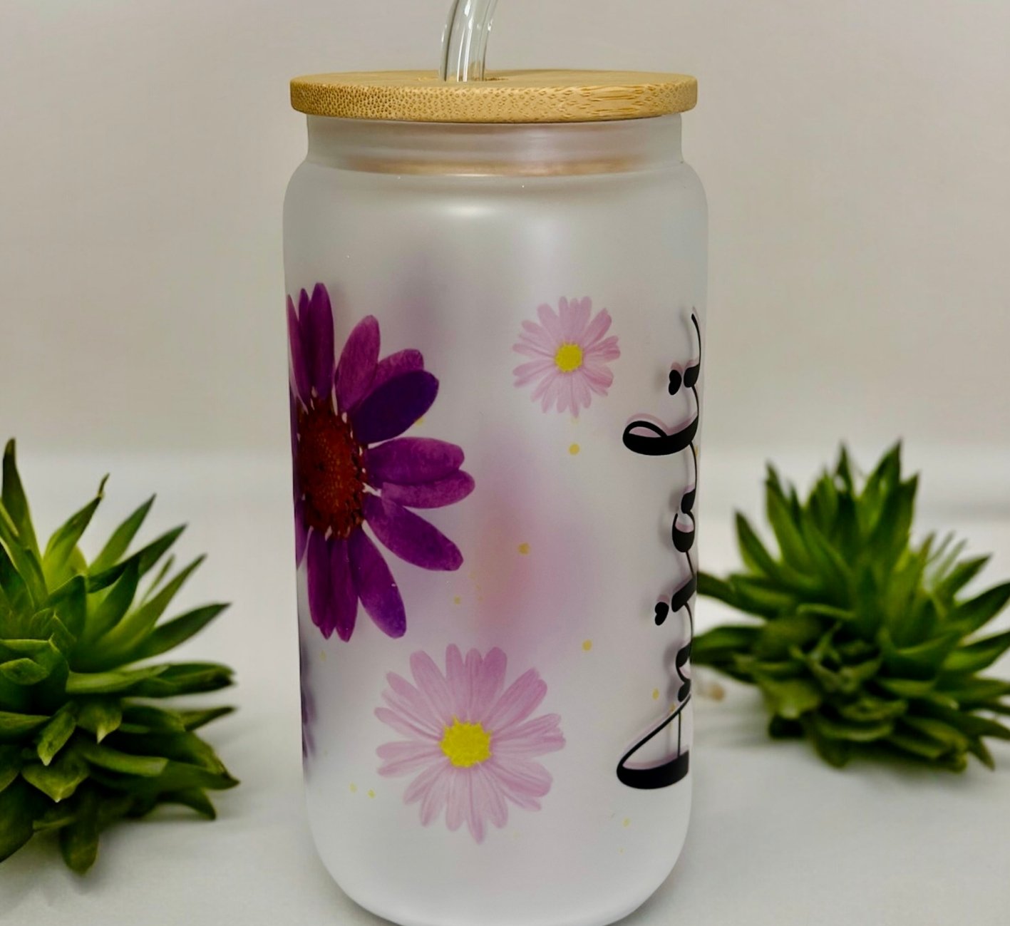 Tumbler with floral design and bamboo lid on a white background
