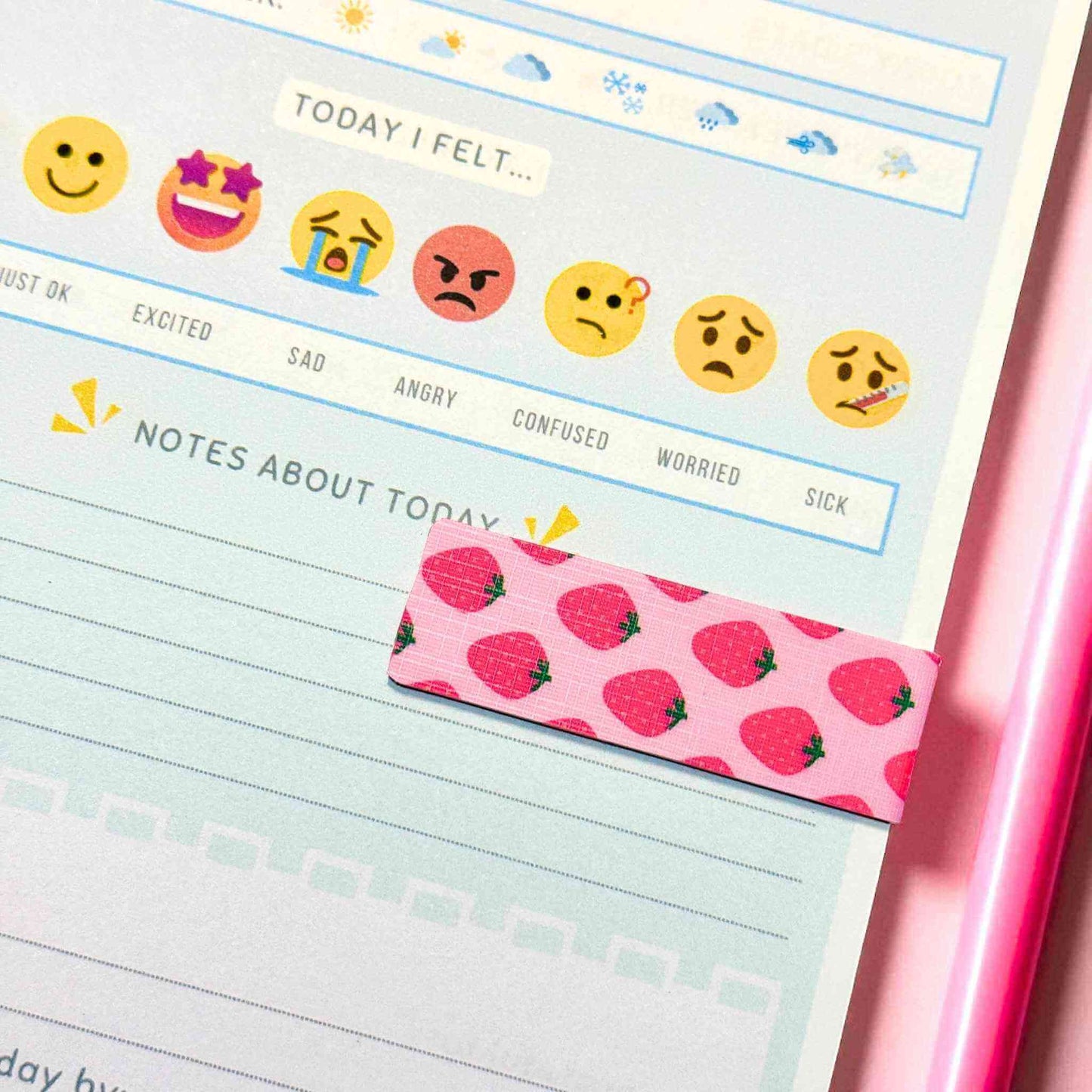 Custom strawberry-themed magnetic bookmark marking page in wellness journal with emoji mood tracker - book accessories shipped nationwide Australia Craftinspired