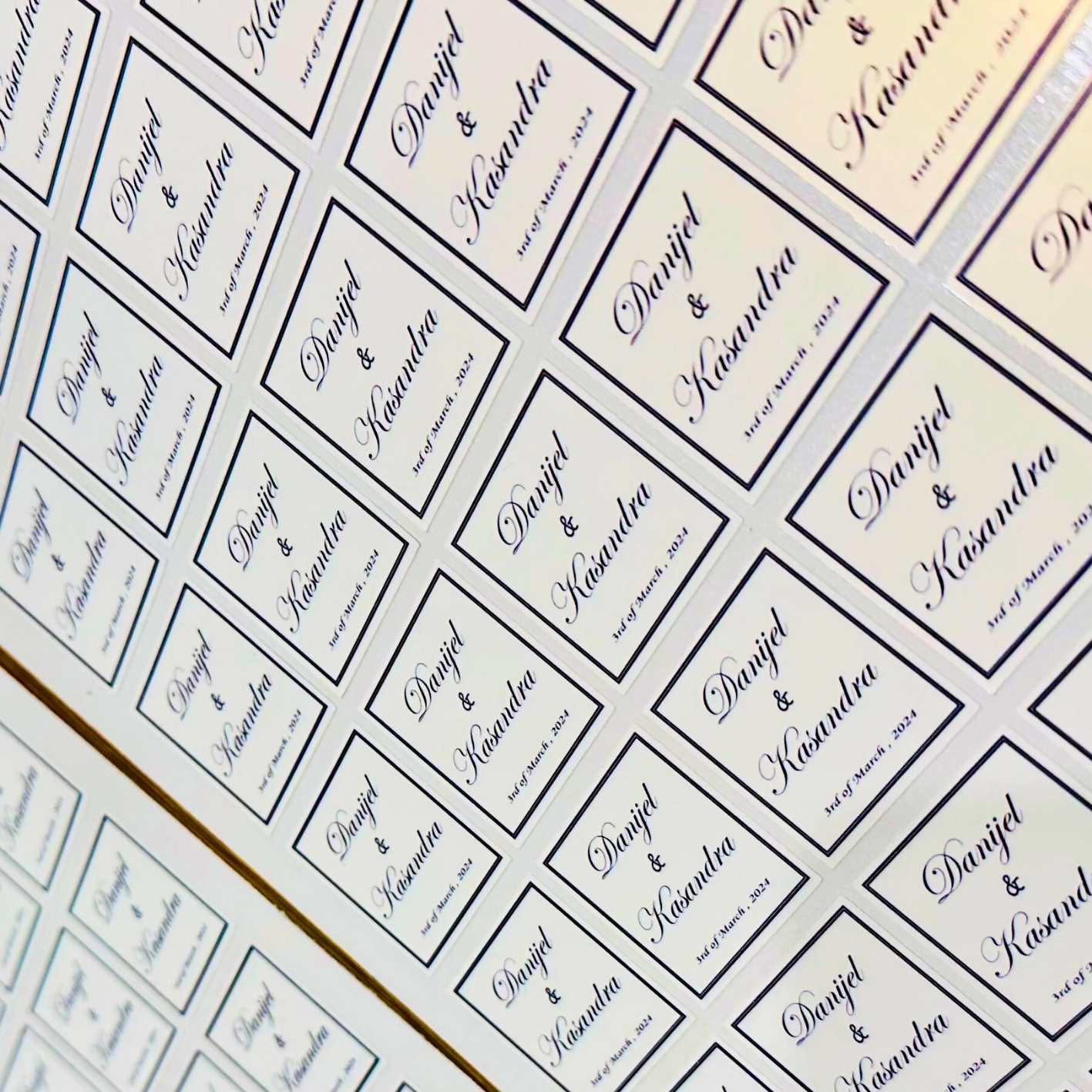 Wedding stickers with couples names and dates.