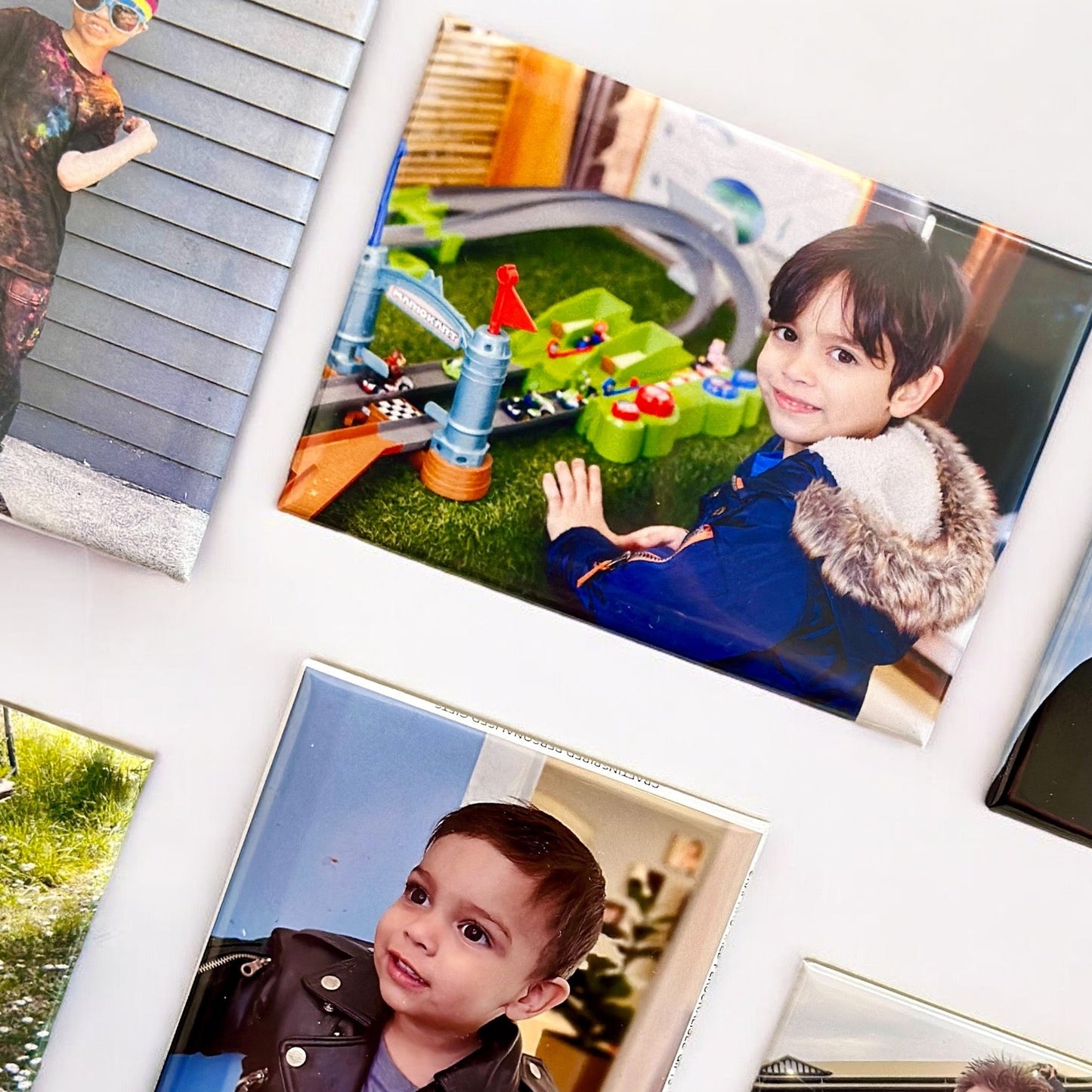 Collage of photos featuring a child at a playground and with family.
Photo tiles rectangle magnets