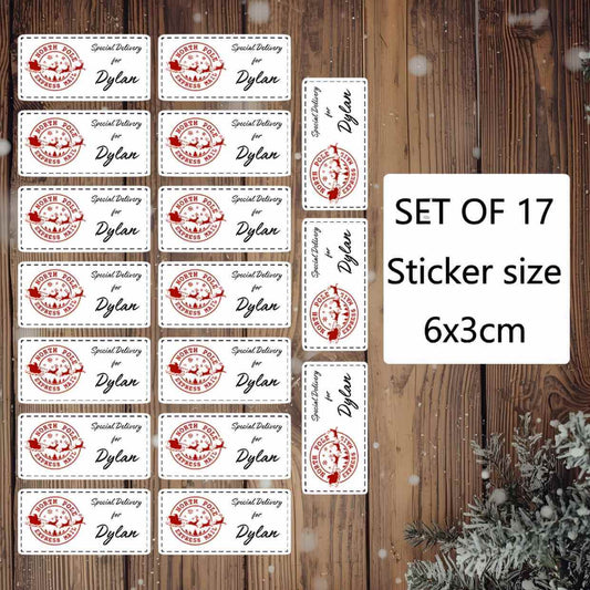 Set of 17 personalised Christmas stickers with a red and white design on a wooden background.