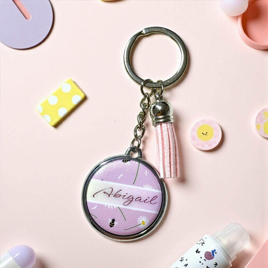Personalised keychain with 'Abigail' on a pink background