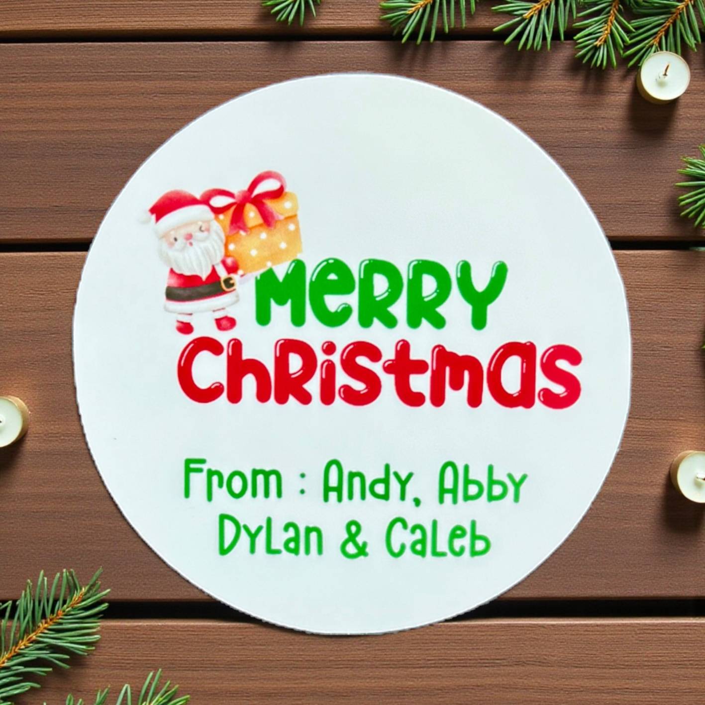 Round Christmas card with Santa Claus and gift, personalized text on a wooden background with Christmas decorations.