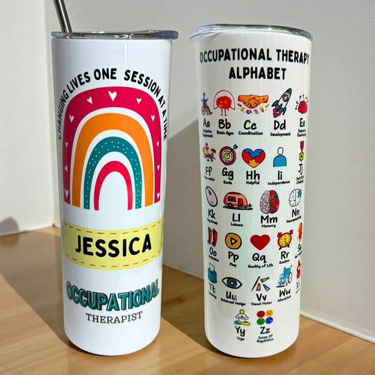 Two tumblers; one with a rainbow design and text, the other with occupational therapy alphabet design.