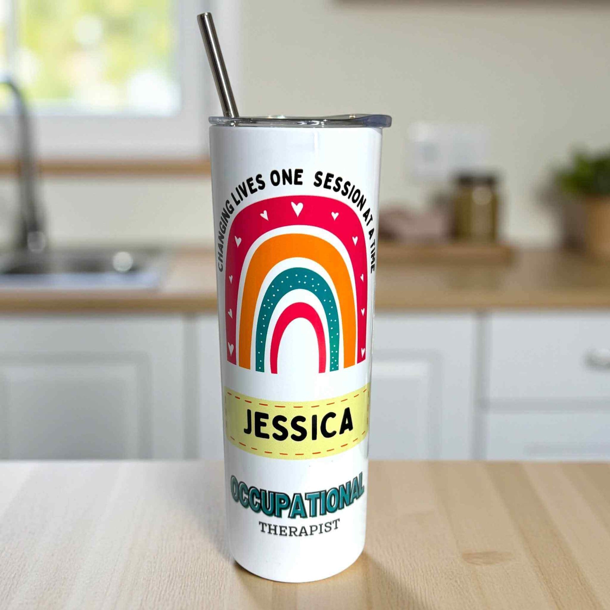 Occupational therapist Tumbler with rainbow design and text on a kitchen counter