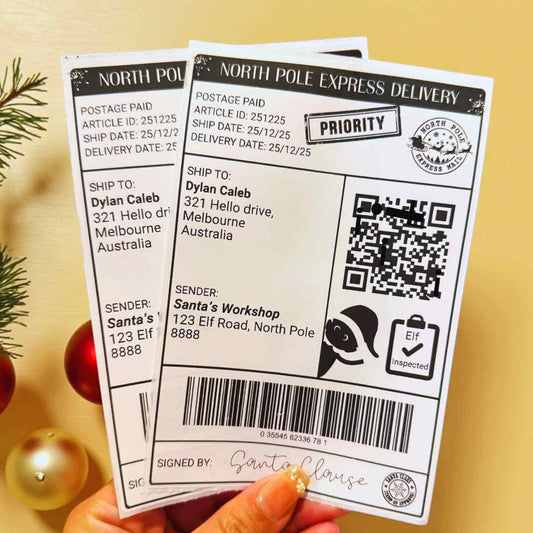 Two Personalised North Pole Express Delivery labels held by a hand on a yellow background with Christmas decorations.