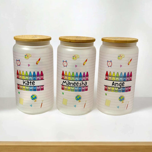 Custom teacher glass can tumblers displaying personalised names and educational themed graphics including crayons, paint palette, and school supplies - handmade teacher gifts