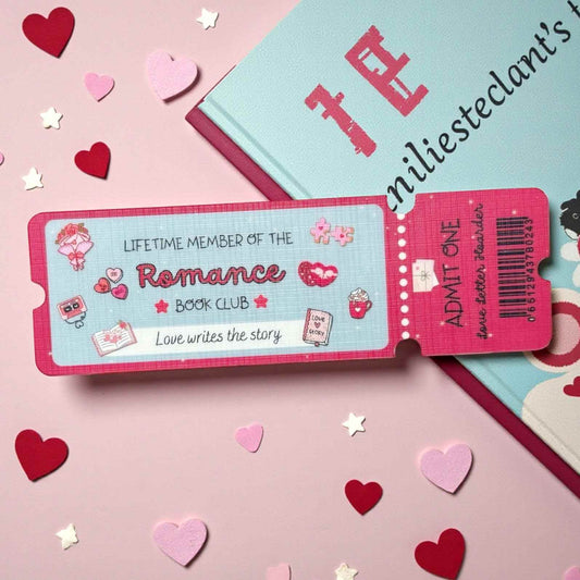 Ticket-shaped card bookmark for 'Lifetime Member of the Romance Book Club' on a pink background with heart decorations.