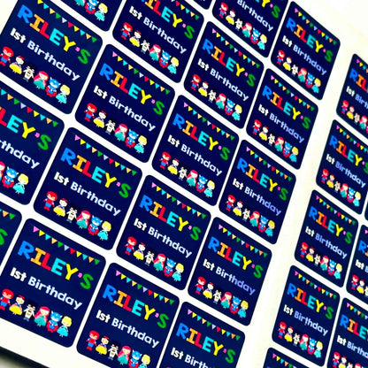 Personalized birthday stickers with 'Riley's 1st Birthday' text and colourful 
Superhero themed custom prints.