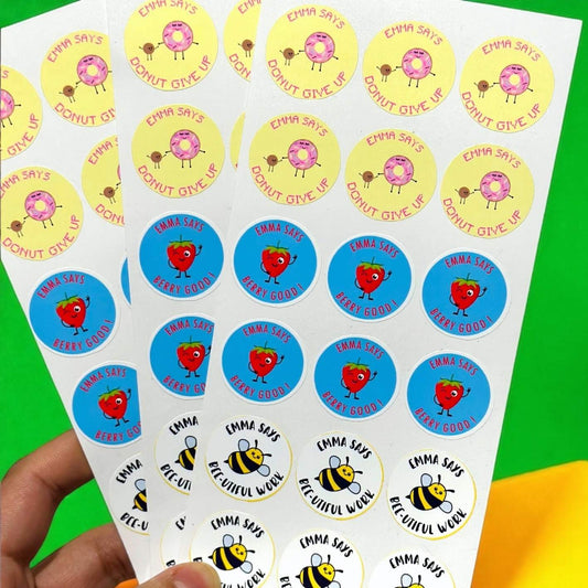 Fun motivational reward stickers for students displayed on a wooden surface