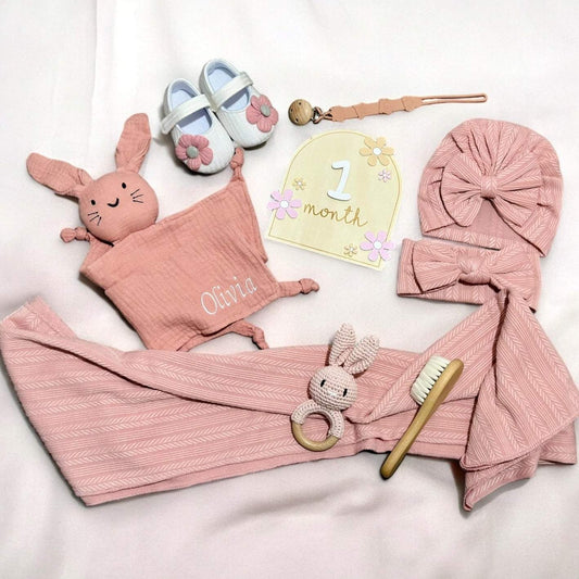 Personalised baby girl gift set with custom comfort toy, crochet bunny, swaddle, and milestone cards