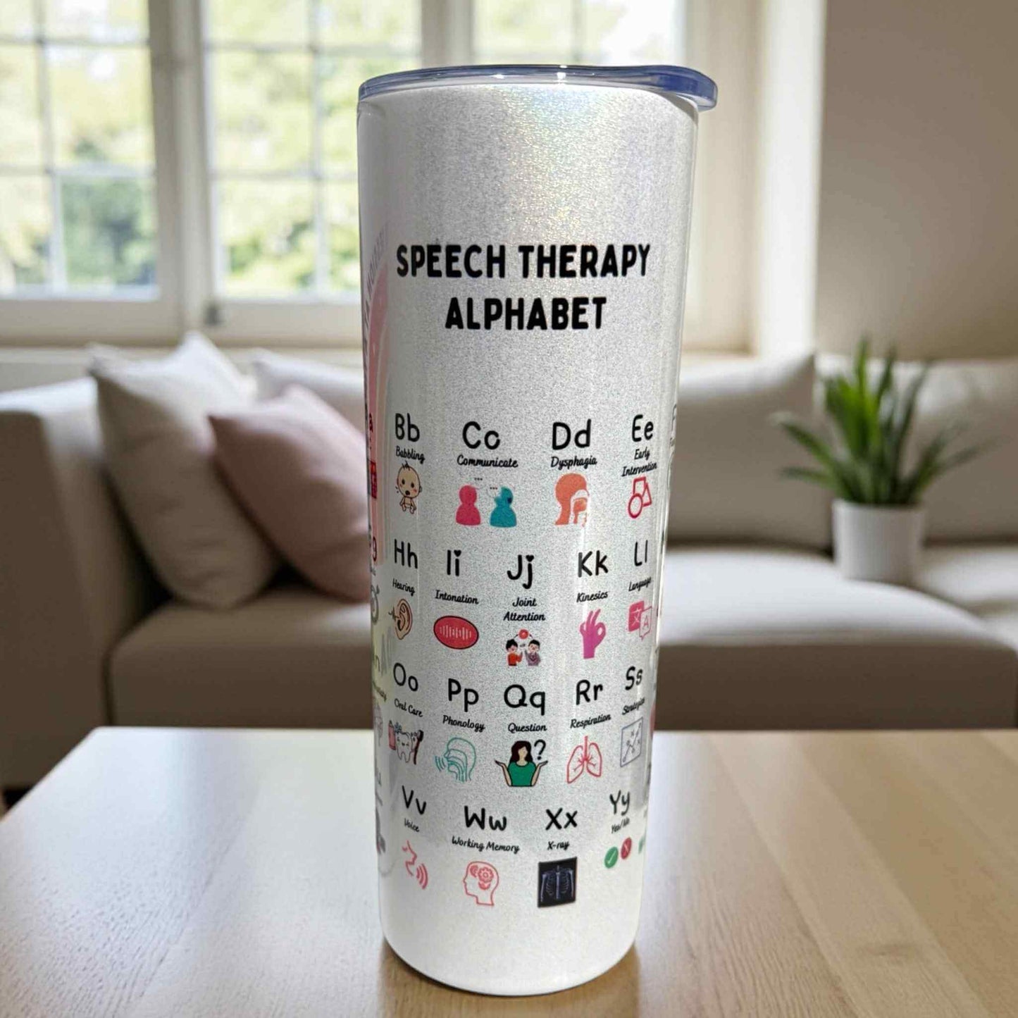 Tumbler with 'Speech Therapy Alphabet' design on a table in a living room.